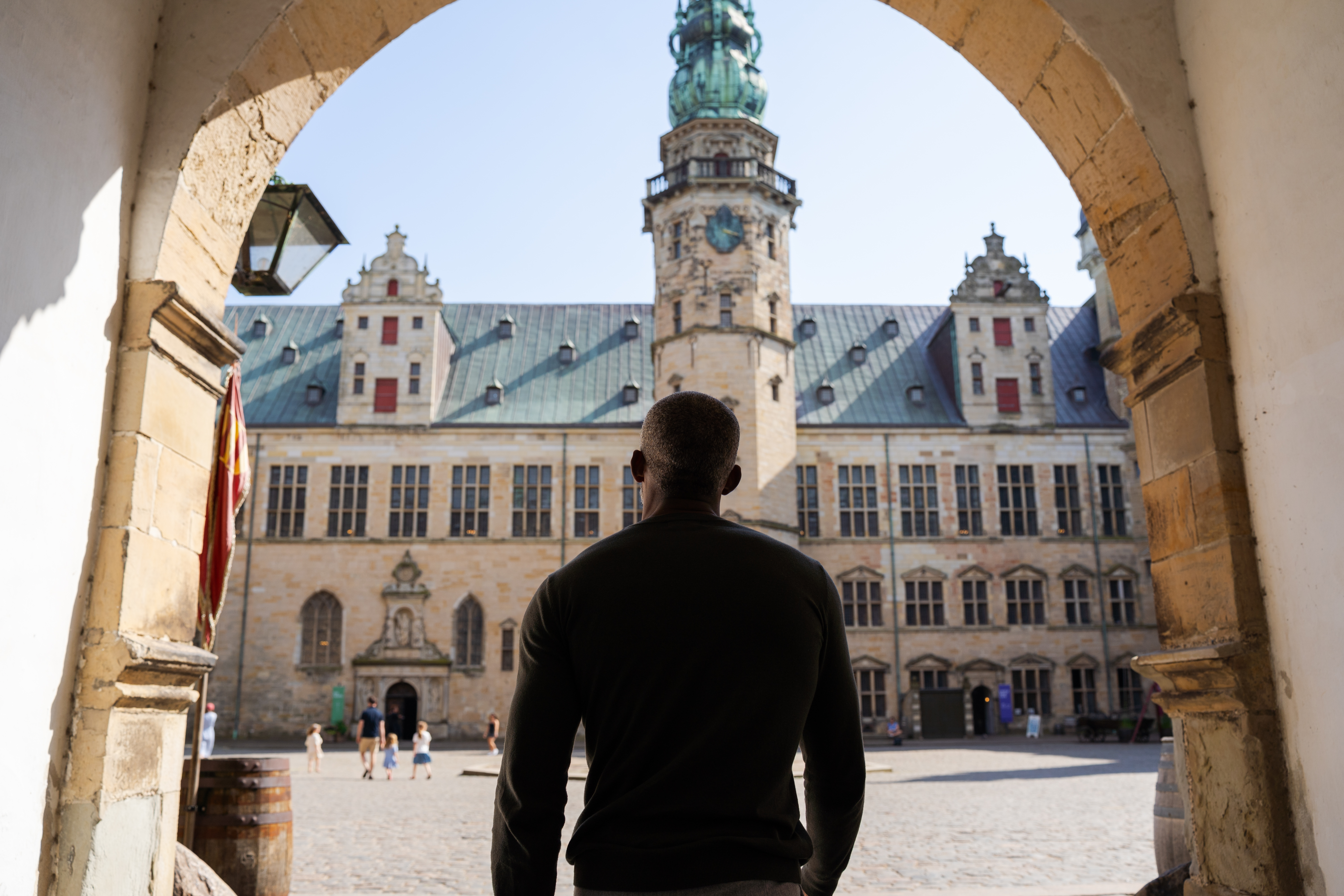 View through a stone arch toward Kronborg Castle courtyard in Helsingor, used as the private Copenhagen experiences cover image.